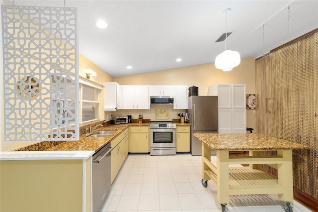 kitchen with stainless steel appliances, hanging light fixtures, white cabinetry, a sink, and a peninsula