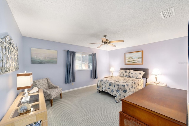 bedroom featuring carpet, visible vents, and a textured ceiling