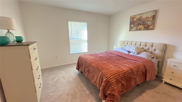 bedroom with carpet floors and baseboards