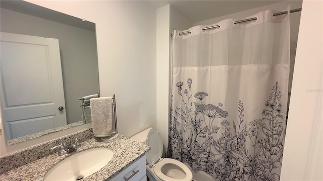 bathroom featuring toilet, a shower with curtain, and vanity