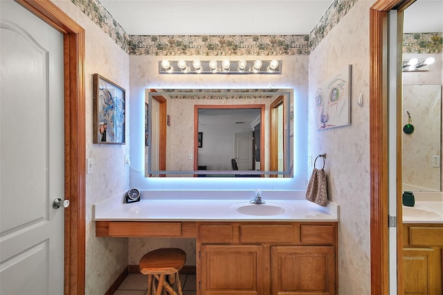 bathroom with vanity, ensuite bath, and wallpapered walls