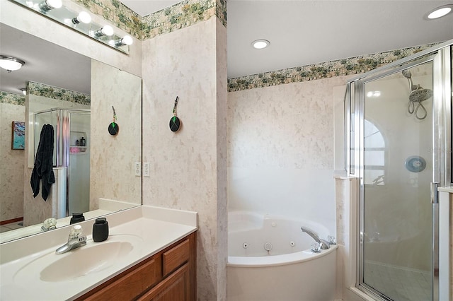 full bath featuring a whirlpool tub, wallpapered walls, a shower stall, and vanity