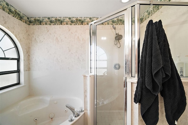 bathroom with a shower stall, a whirlpool tub, and wallpapered walls