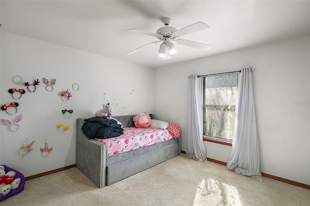 bedroom featuring ceiling fan, light carpet, and baseboards