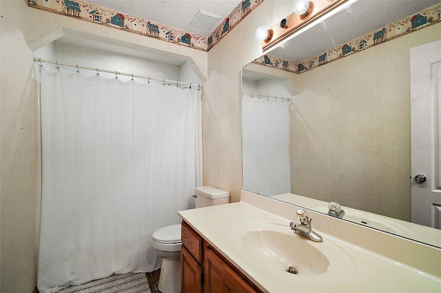 bathroom with toilet, visible vents, and vanity