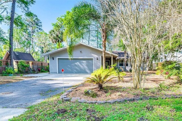 ranch-style home with a garage and driveway