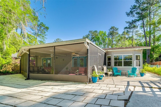 back of house with a sunroom, a patio, and ceiling fan