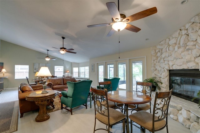 dining space featuring a wealth of natural light, french doors, a fireplace, and lofted ceiling