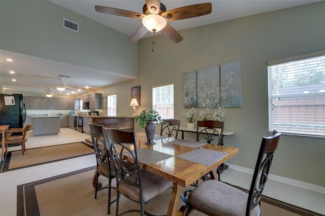 dining room with recessed lighting, visible vents, a high ceiling, a ceiling fan, and baseboards