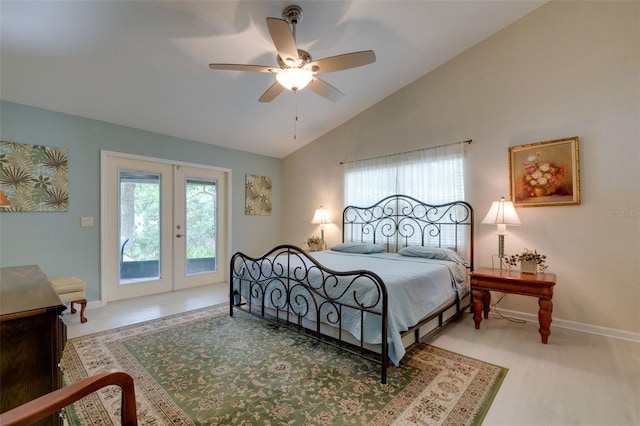 bedroom featuring lofted ceiling, french doors, multiple windows, and access to exterior