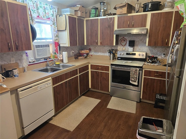 kitchen featuring under cabinet range hood, dark wood-type flooring, a sink, light countertops, and appliances with stainless steel finishes