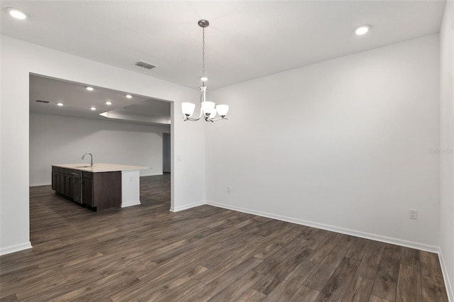 interior space with baseboards, visible vents, and dark wood-type flooring