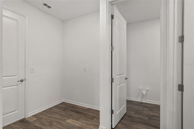 interior space with dark wood-type flooring, visible vents, and baseboards