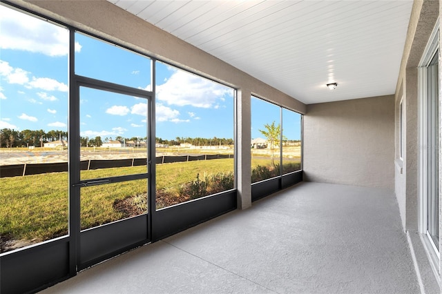 unfurnished sunroom with a rural view