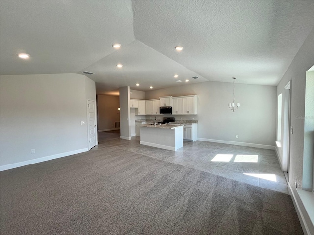 unfurnished living room featuring light carpet, lofted ceiling, visible vents, and baseboards