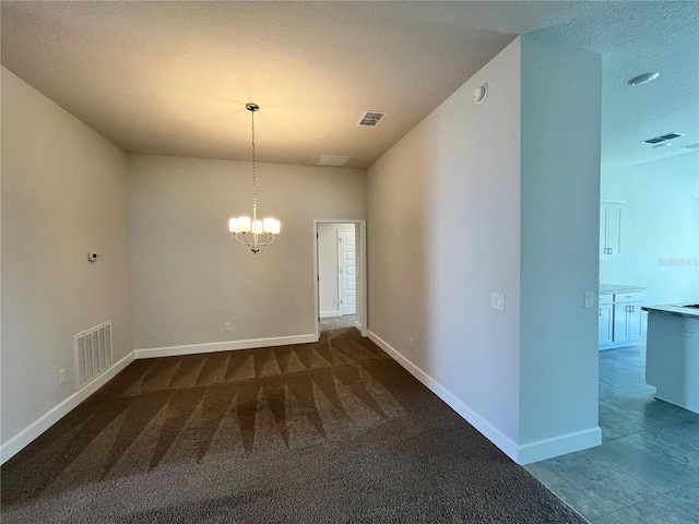 interior space featuring visible vents, a chandelier, and a textured ceiling