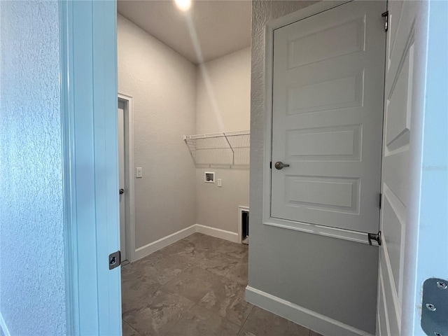 laundry area with laundry area, hookup for a washing machine, and baseboards