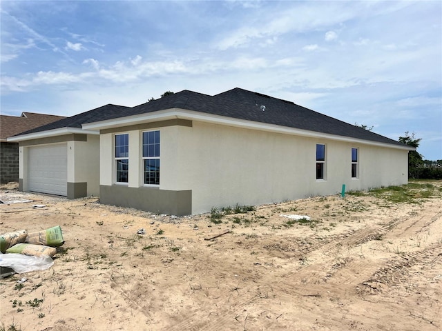 4381 SW 90th Pl, Ocala, FL 34476 - view of side of home with a garage and stucco siding