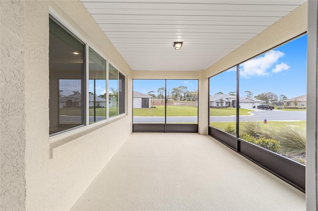 unfurnished sunroom with a residential view