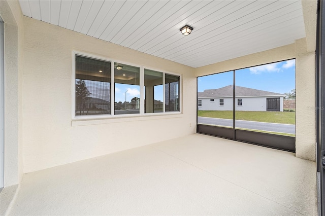 unfurnished sunroom featuring wood ceiling