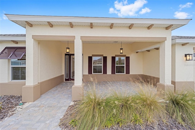 property entrance with stucco siding