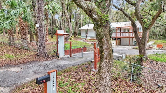 exterior space with aphalt driveway and a gate