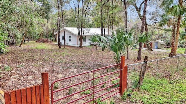 view of yard with a storage shed, an outdoor structure, and fence private yard