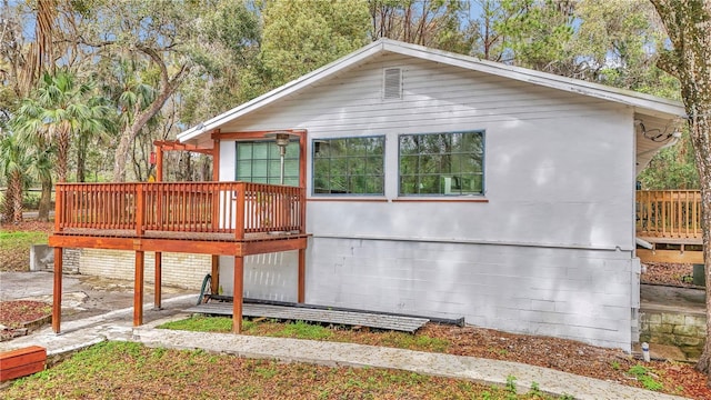 view of home's exterior featuring a wooden deck