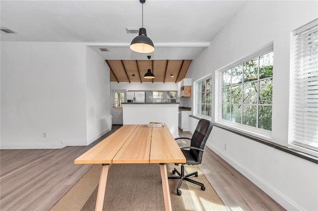 office area featuring vaulted ceiling with beams, plenty of natural light, and visible vents