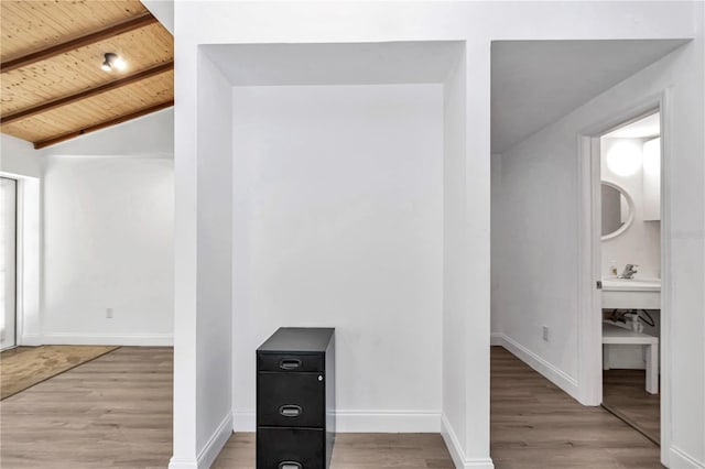 interior space with wooden ceiling, baseboards, and light wood finished floors