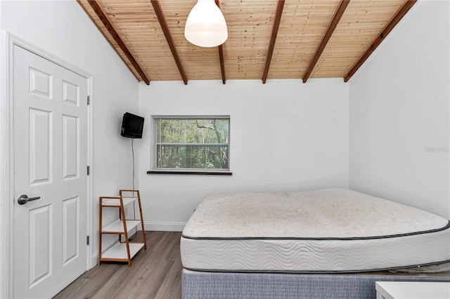 bedroom with wooden ceiling, lofted ceiling with beams, and wood finished floors