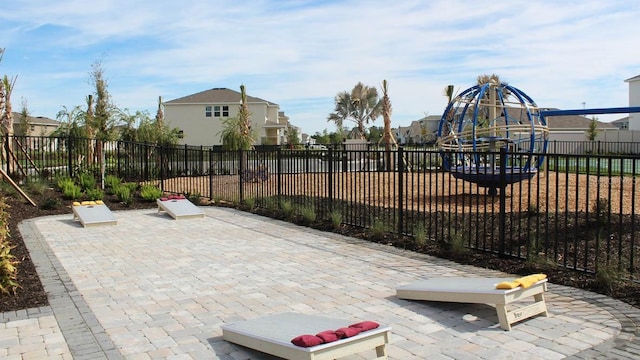 view of patio / terrace with fence and a playground