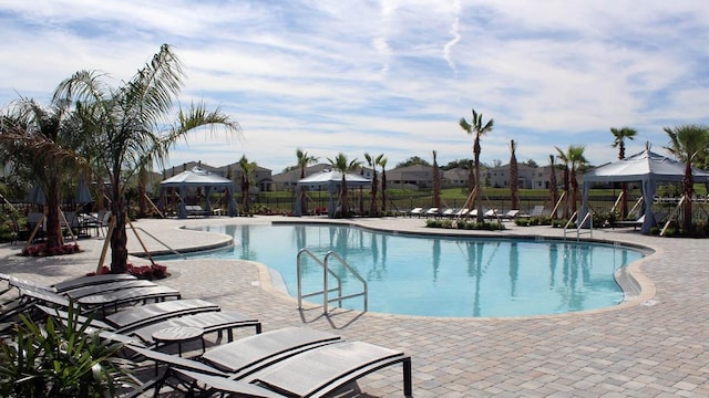 pool featuring a patio area, fence, and a gazebo