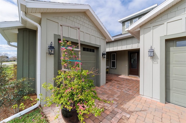 entrance to property featuring board and batten siding and an attached garage