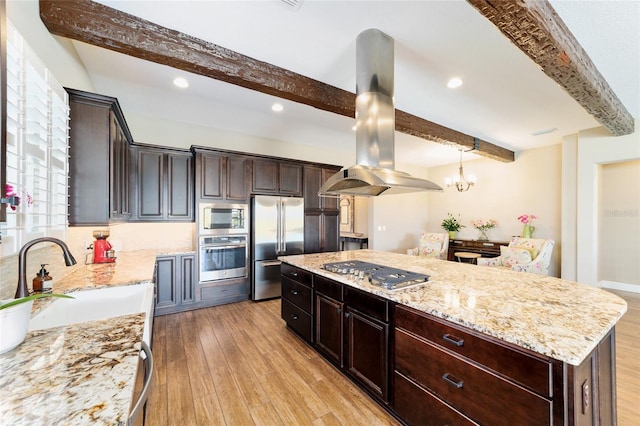 kitchen with stainless steel appliances, a sink, light wood-style flooring, and island range hood