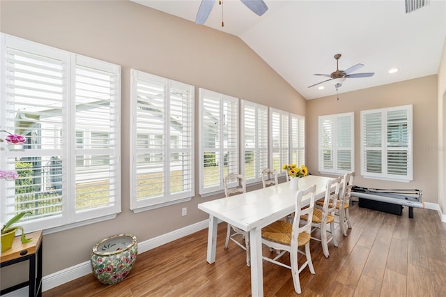 dining space with plenty of natural light, visible vents, vaulted ceiling, and wood finished floors