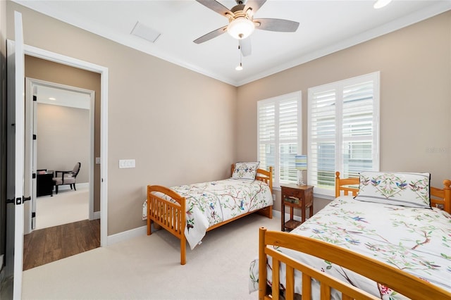 bedroom with baseboards, carpet, a ceiling fan, and crown molding