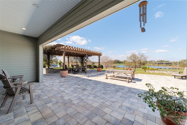 view of patio featuring a water view, outdoor dining area, and a pergola