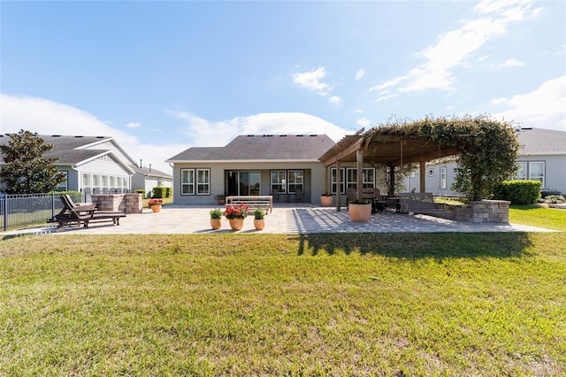 rear view of property with a patio, a yard, and fence