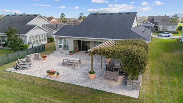 back of property with a patio area, a residential view, and a lawn