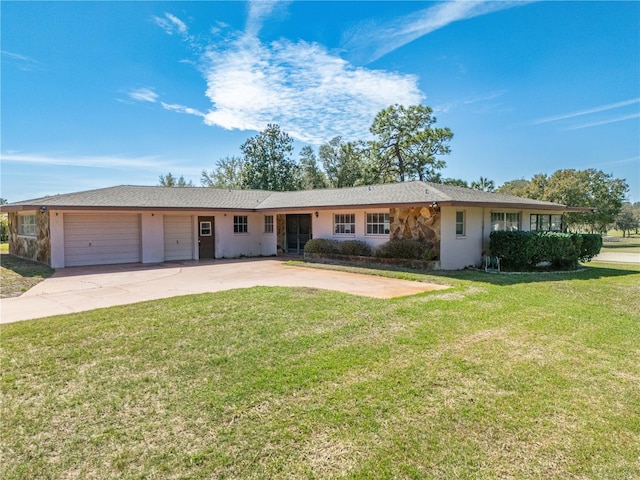 ranch-style house with a garage, concrete driveway, and a front yard