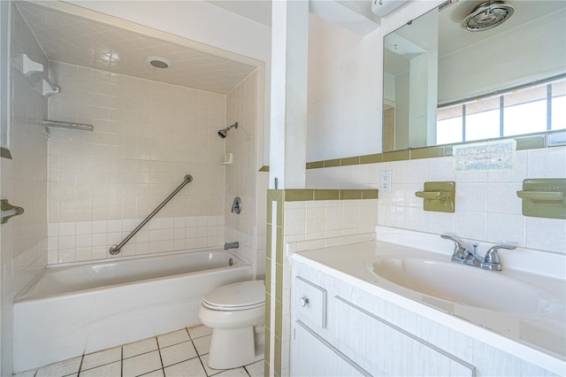 full bathroom featuring bathtub / shower combination, toilet, vanity, tile walls, and tile patterned floors