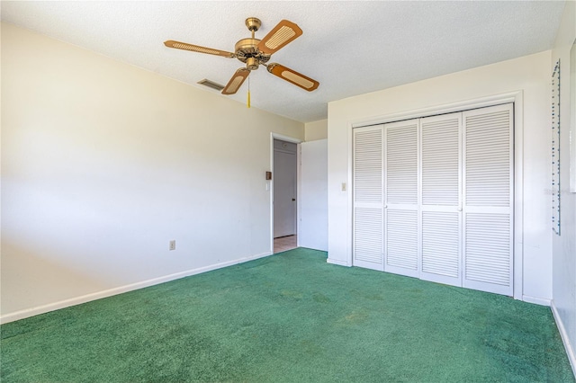 unfurnished bedroom with carpet floors, a closet, visible vents, and a textured ceiling