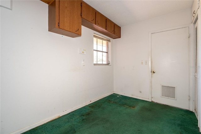 unfurnished room featuring dark colored carpet, visible vents, and baseboards