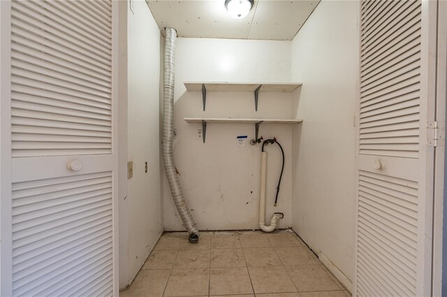 laundry area with hookup for a washing machine, laundry area, electric dryer hookup, and light tile patterned flooring