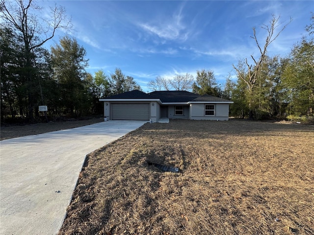 single story home with a garage and concrete driveway