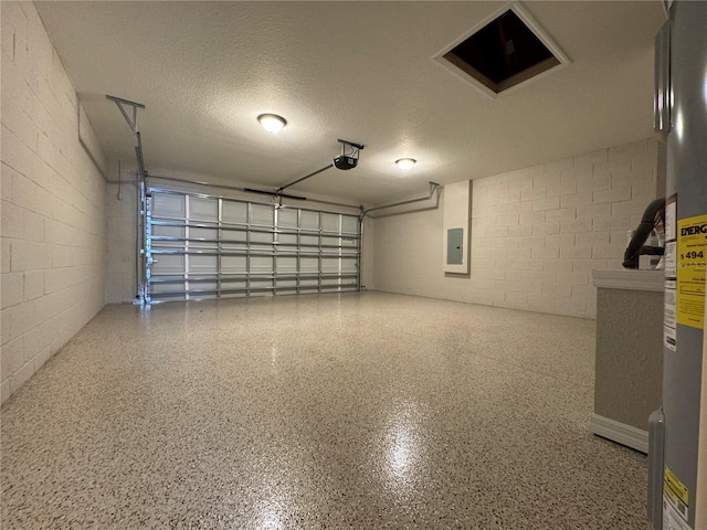 garage featuring concrete block wall, electric panel, and a garage door opener