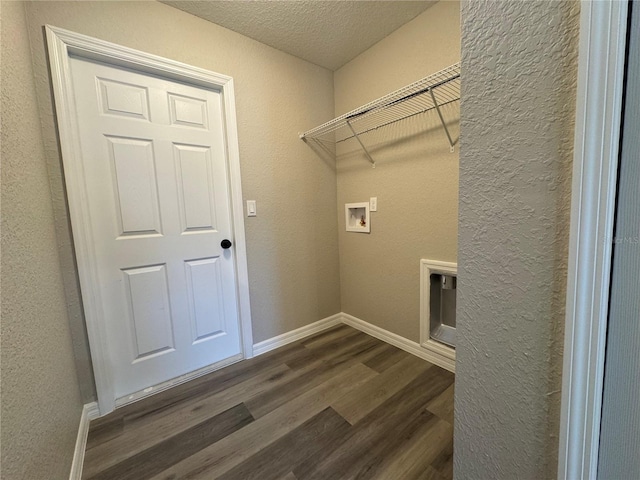 washroom featuring washer hookup, laundry area, dark wood finished floors, and baseboards