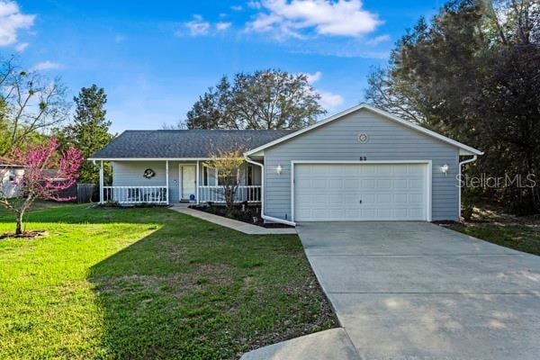 single story home with an attached garage, driveway, a porch, and a front yard