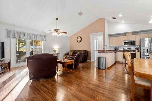 living room featuring high vaulted ceiling, wood finished floors, visible vents, and a ceiling fan